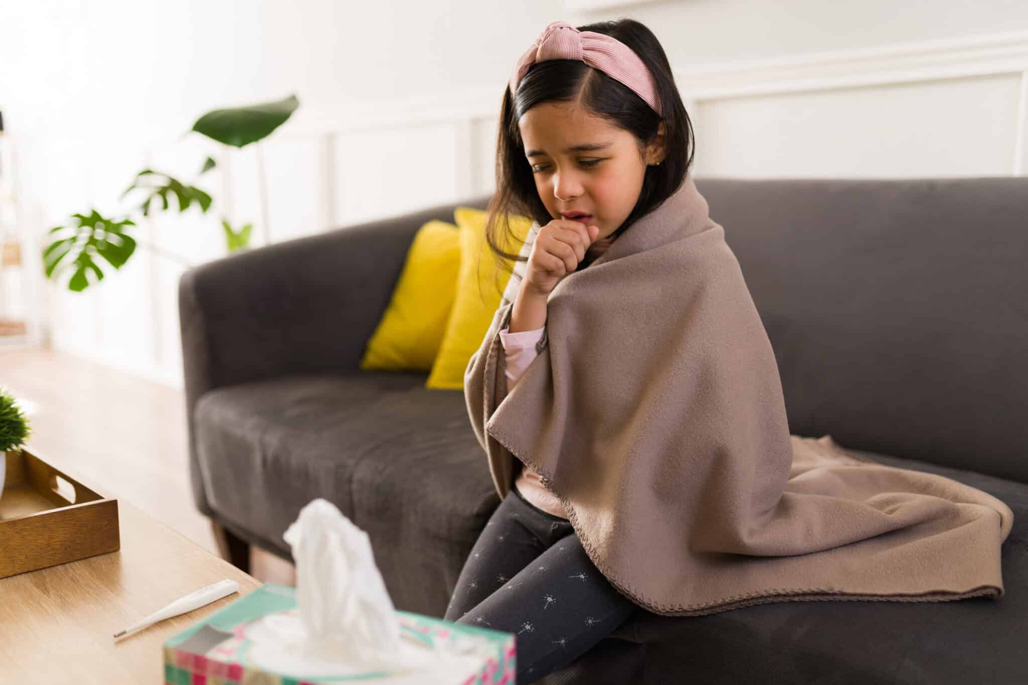 Little girl with a cough reseting at home.