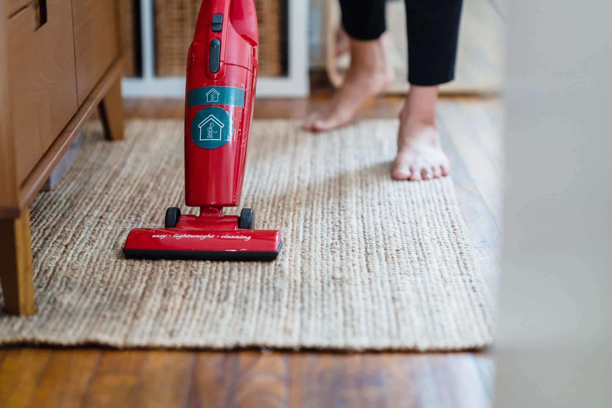 Woman vacuuming her home.