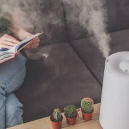 Woman reading next to a humidifier