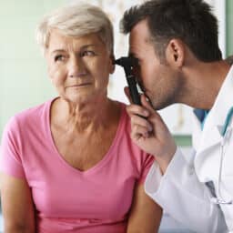ENT examining his patient's ear