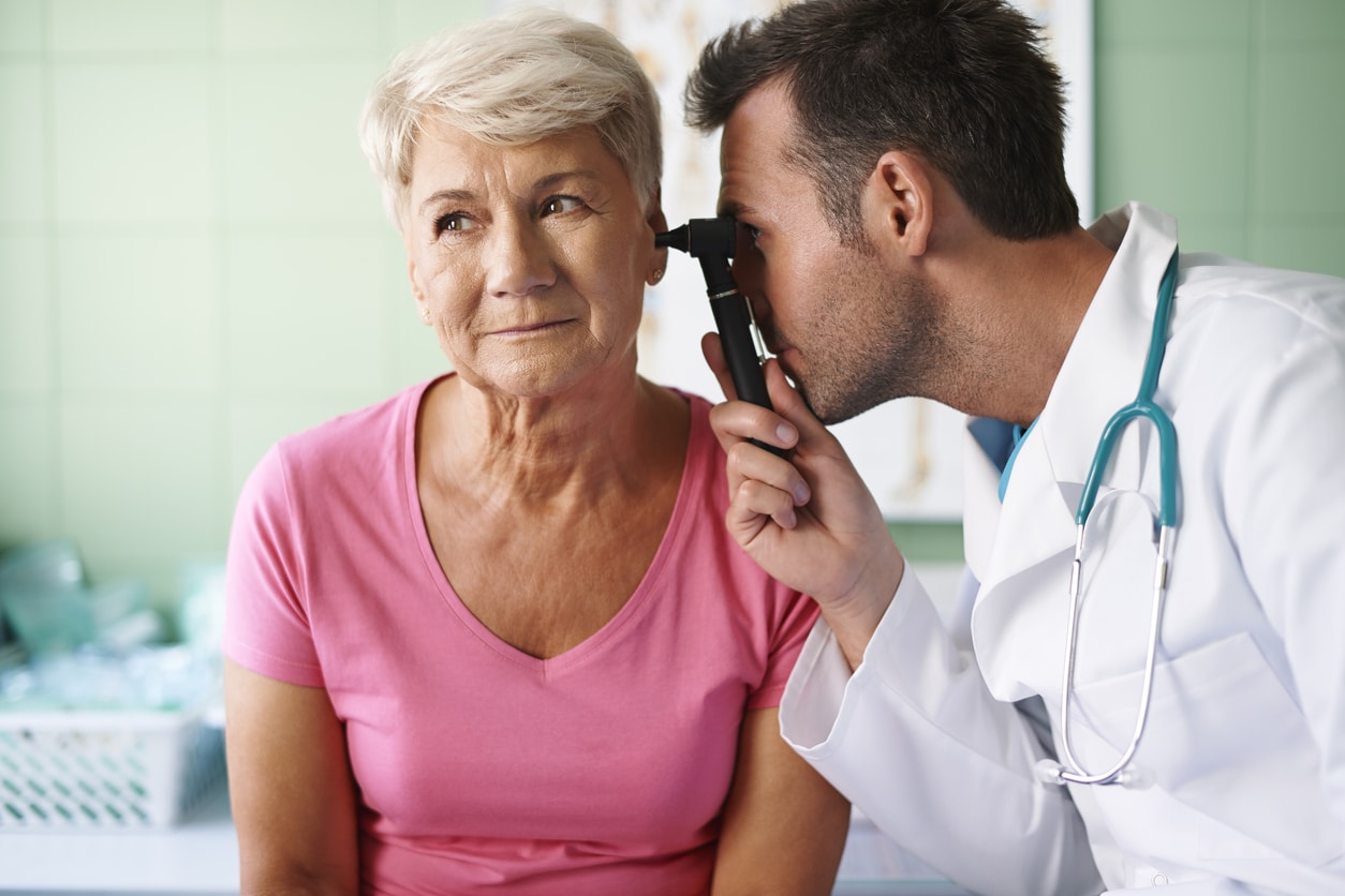 ENT examining his patient's ear.