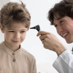 Young boy smiling in an ear exam